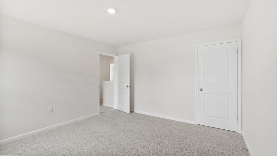 Bedroom with carpet and window.