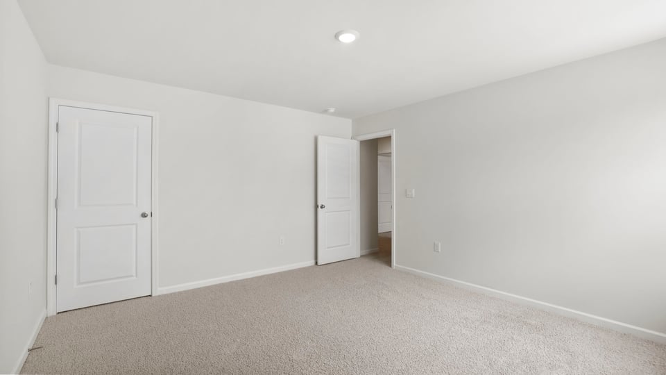 Bedroom with carpet and window.