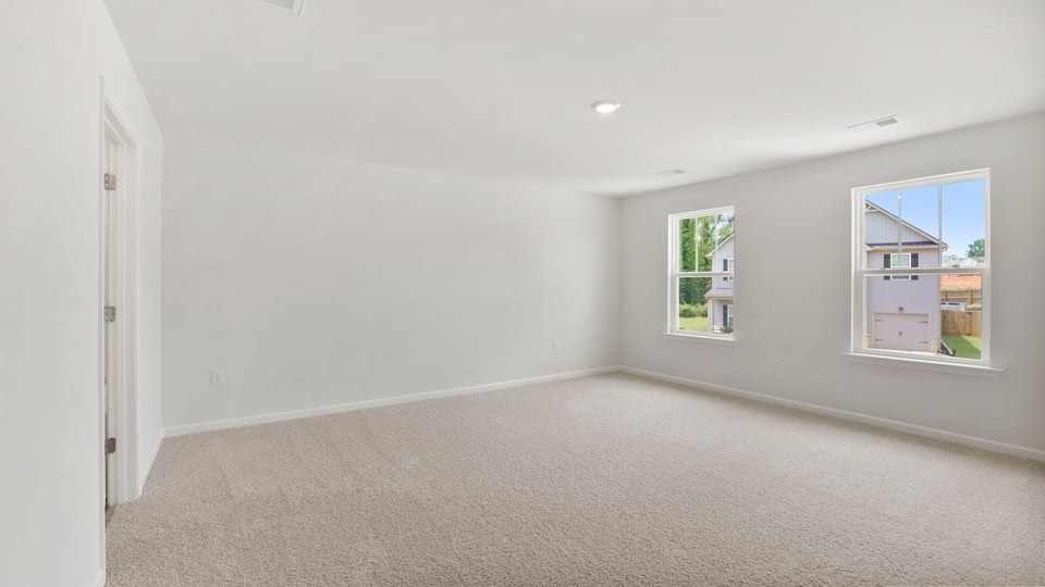 Bedroom with carpet and window.