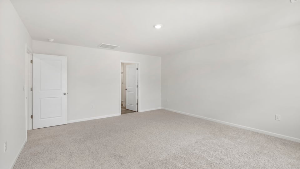 Bedroom with carpet and window.