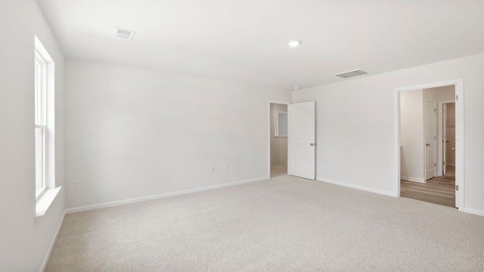 Bedroom with carpet and window.
