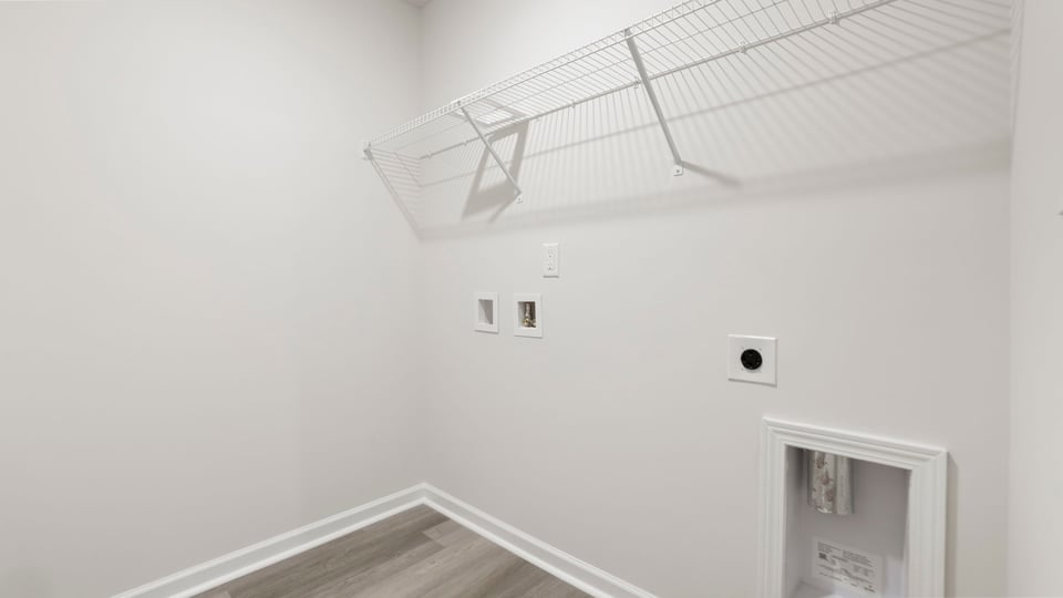 Laundry room with hanging storage racks.