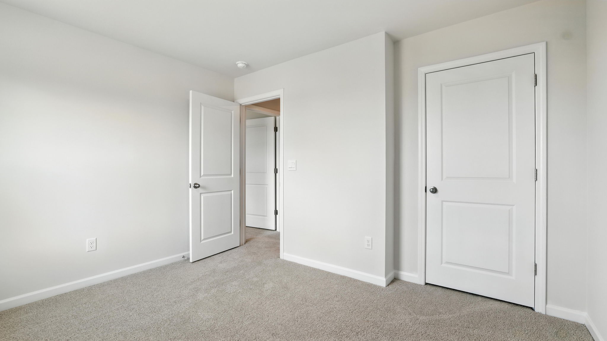 Bedroom with window and carpet.