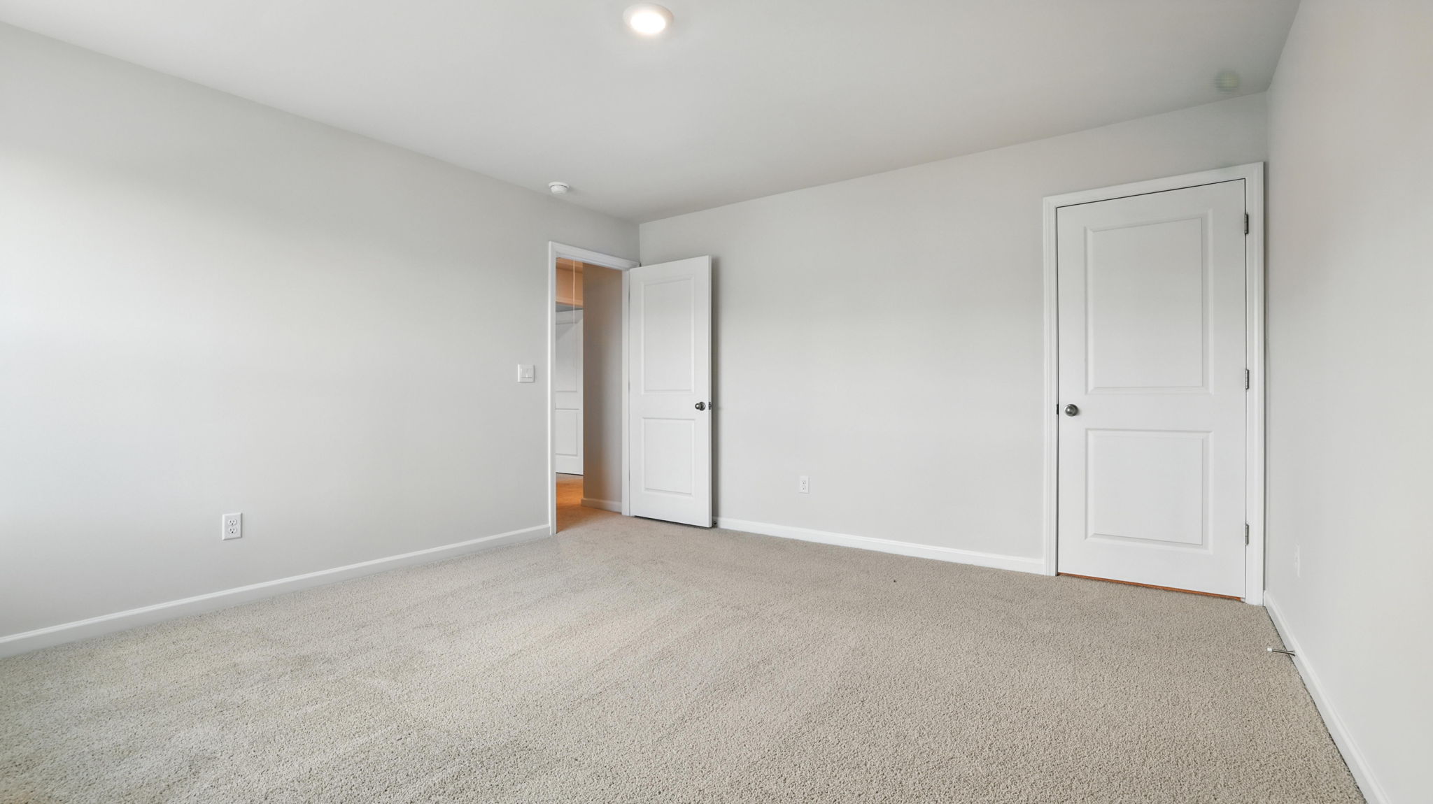 Bedroom with window and carpet.