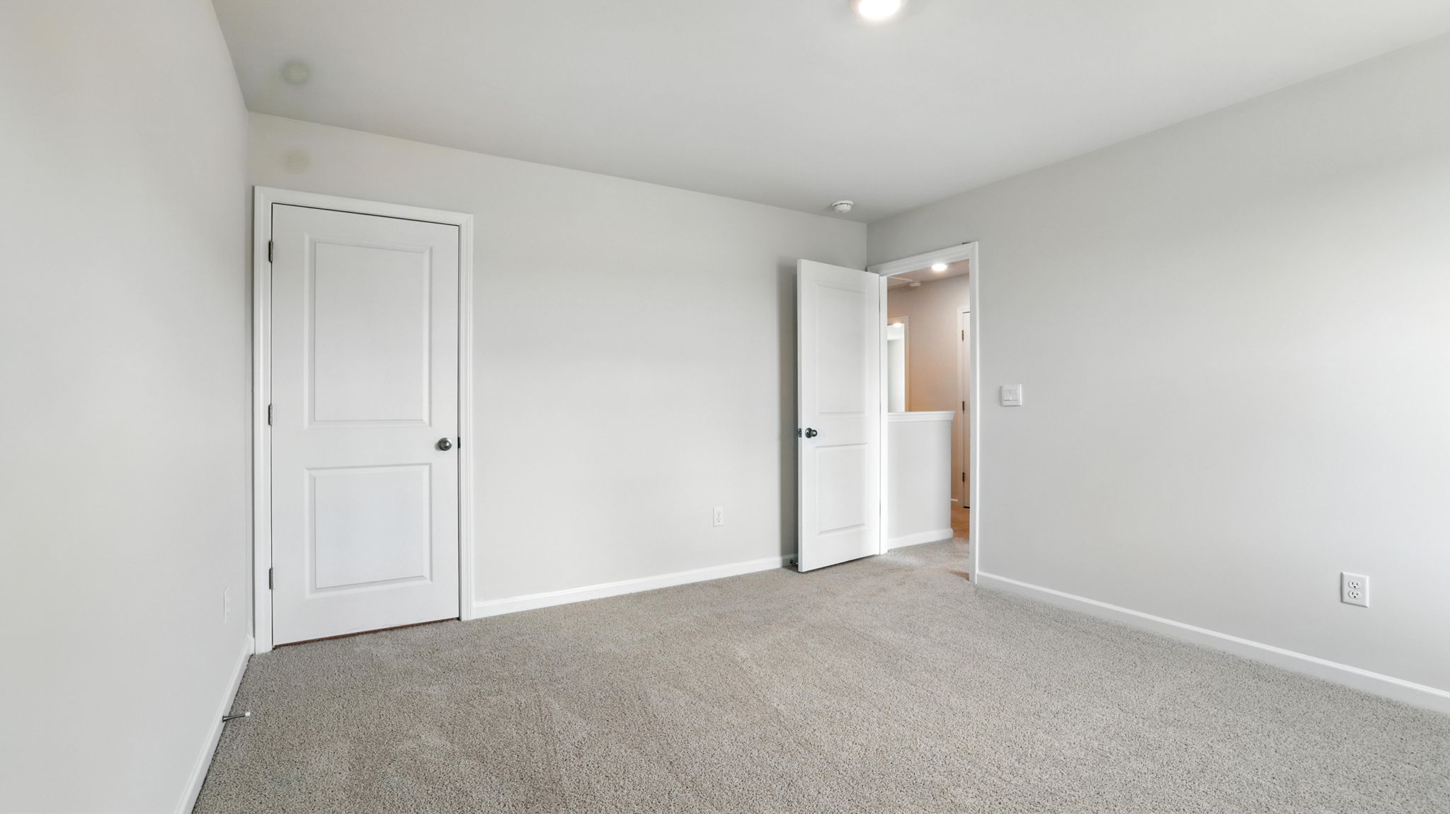 Bedroom with window and carpet.