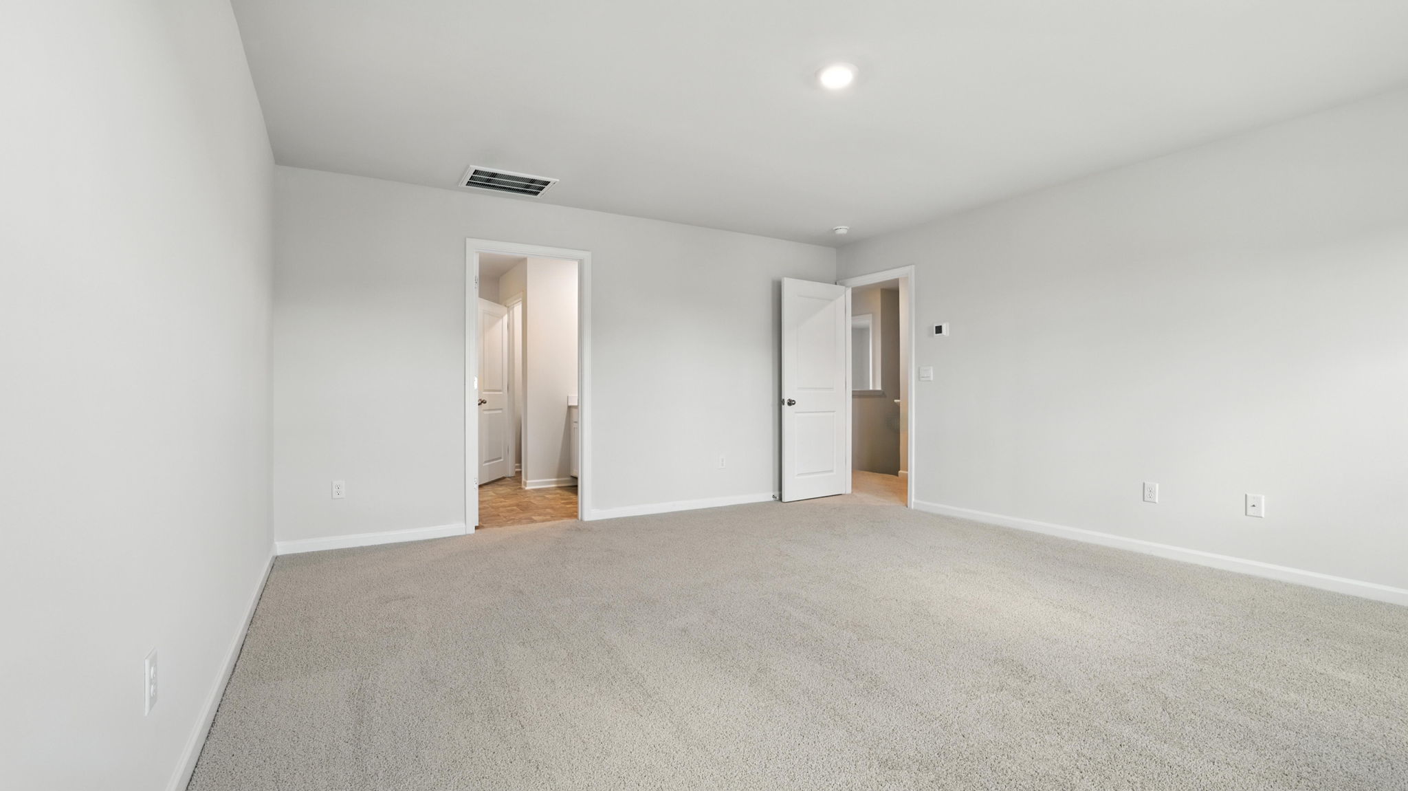 Bedroom with window and carpet.