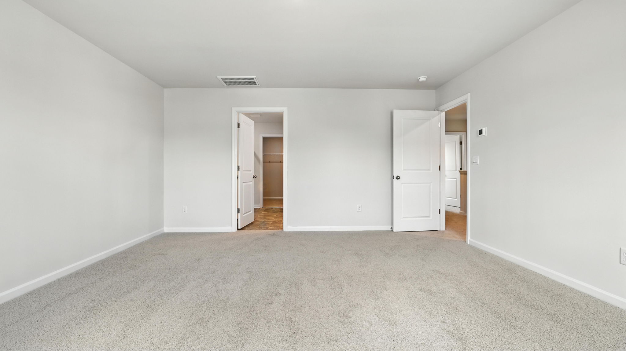 Bedroom with window and carpet.