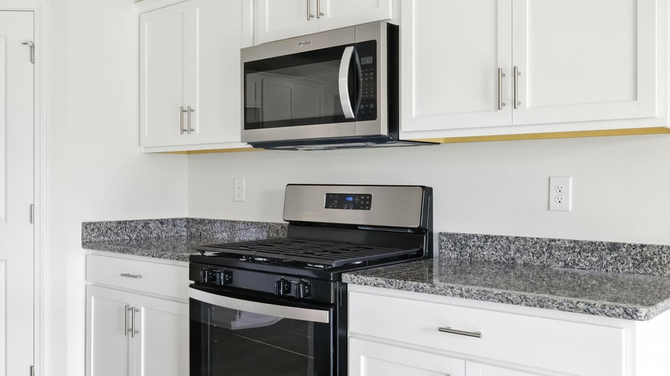 Kitchen and island with granite counter tops.