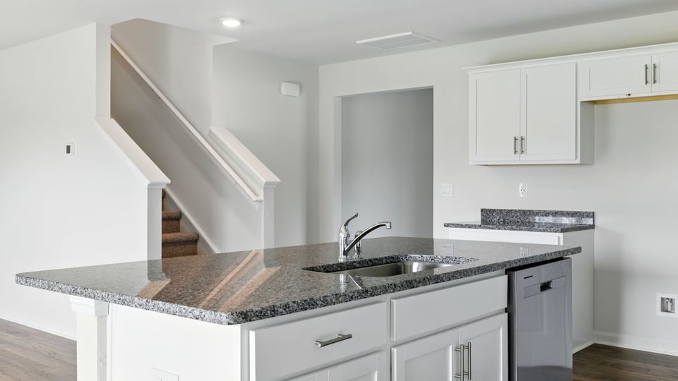 Kitchen and island with granite counter tops.