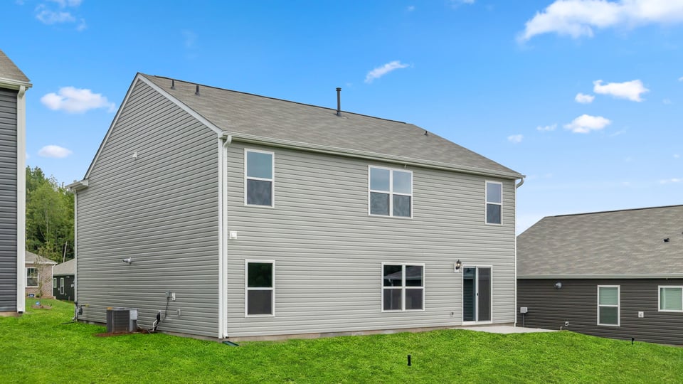 Exterior of home with large backyard.