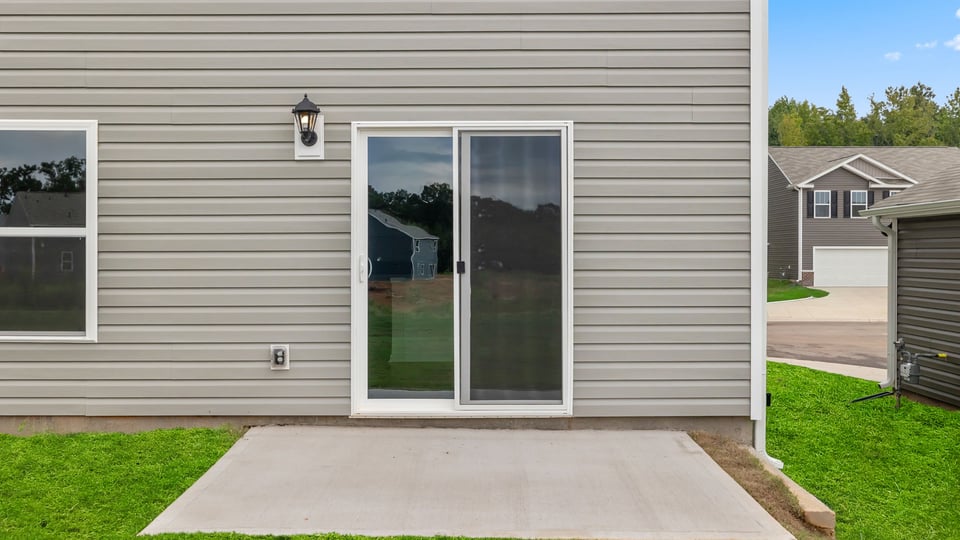 Exterior of home with large backyard.