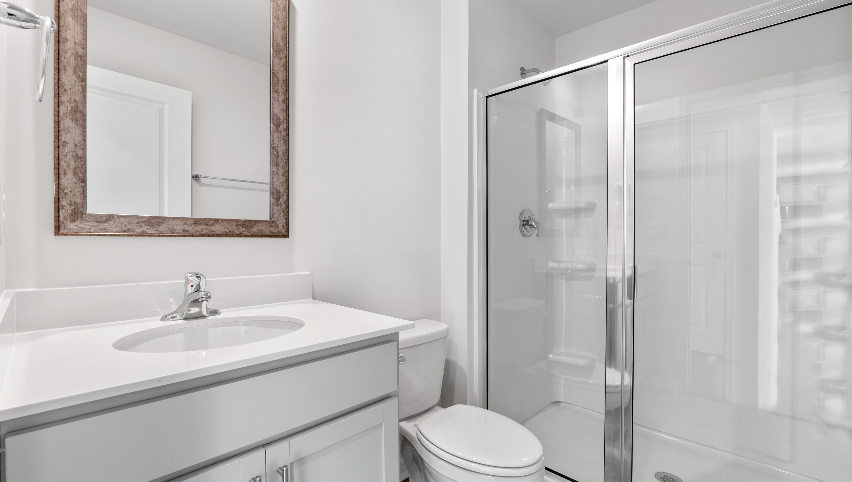 Bathroom with vanity and shower.