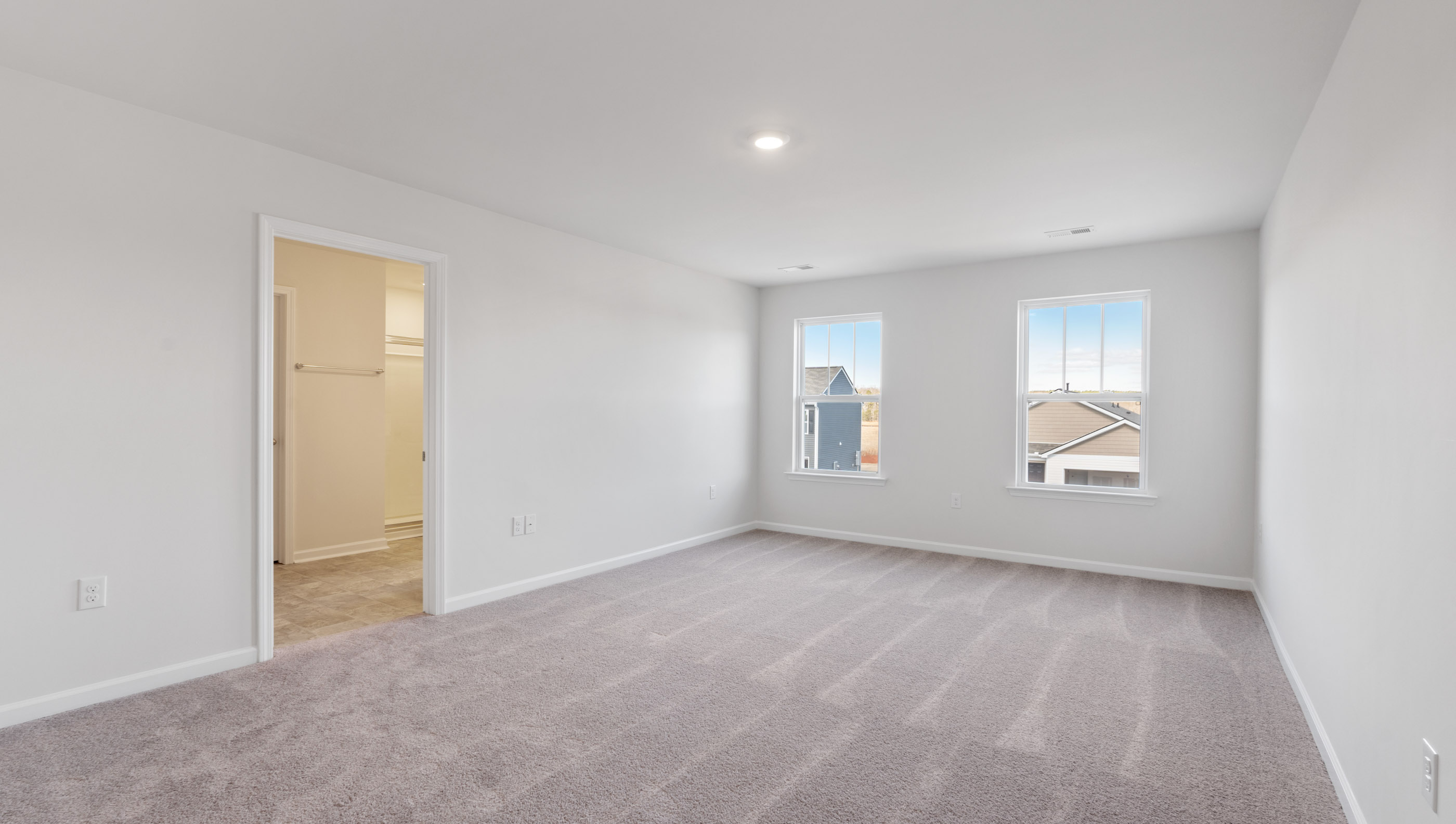 Bedroom with carpet and windows.