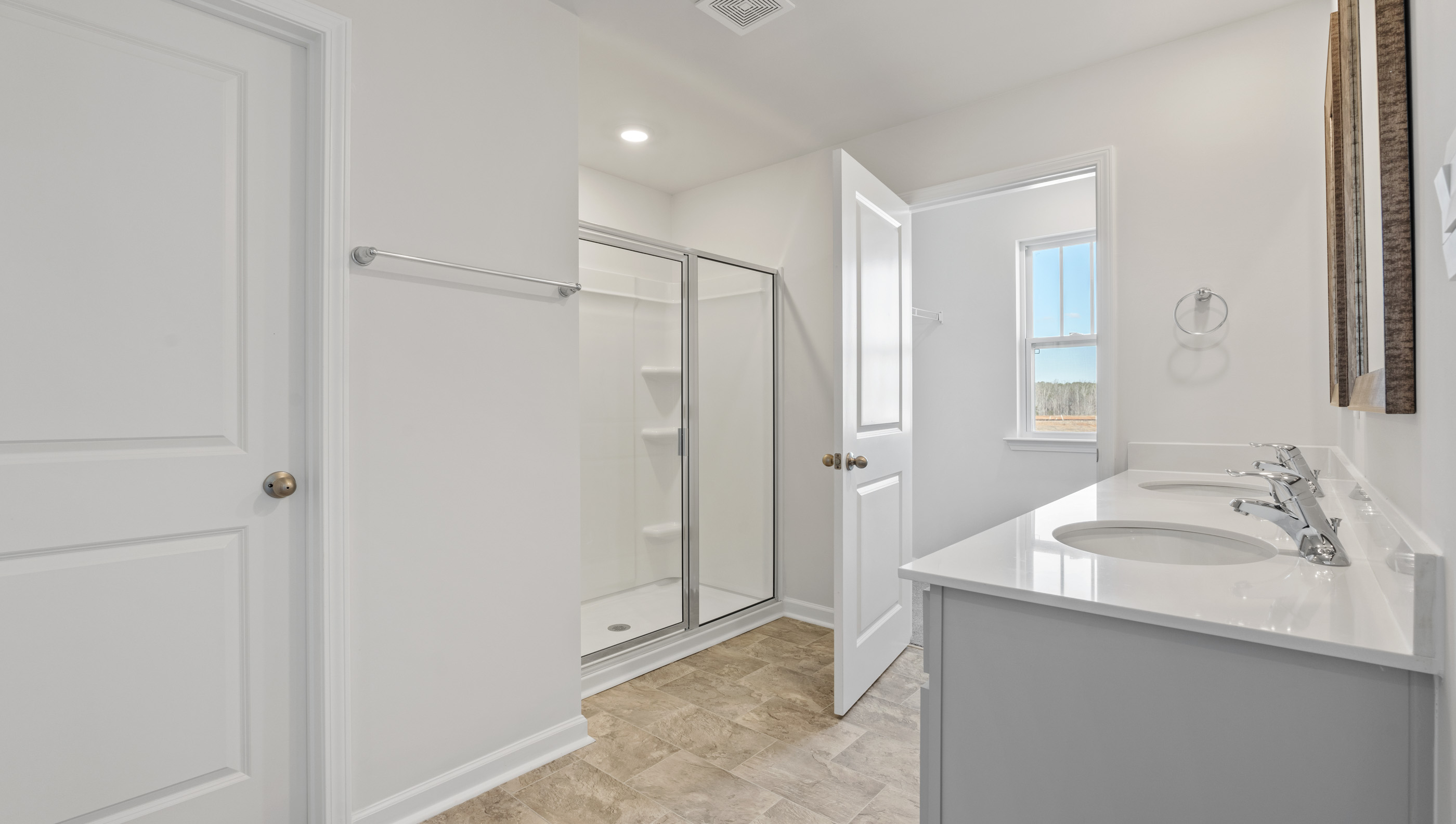 Bathroom with vanity and shower.