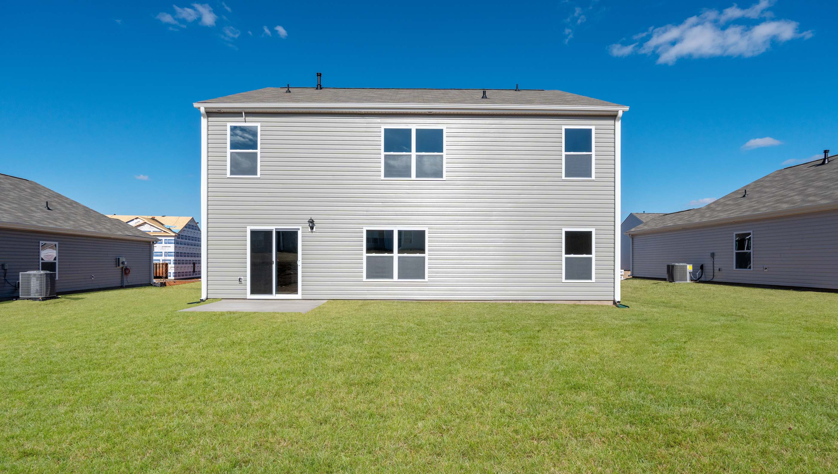 Exterior of home with large backyard.