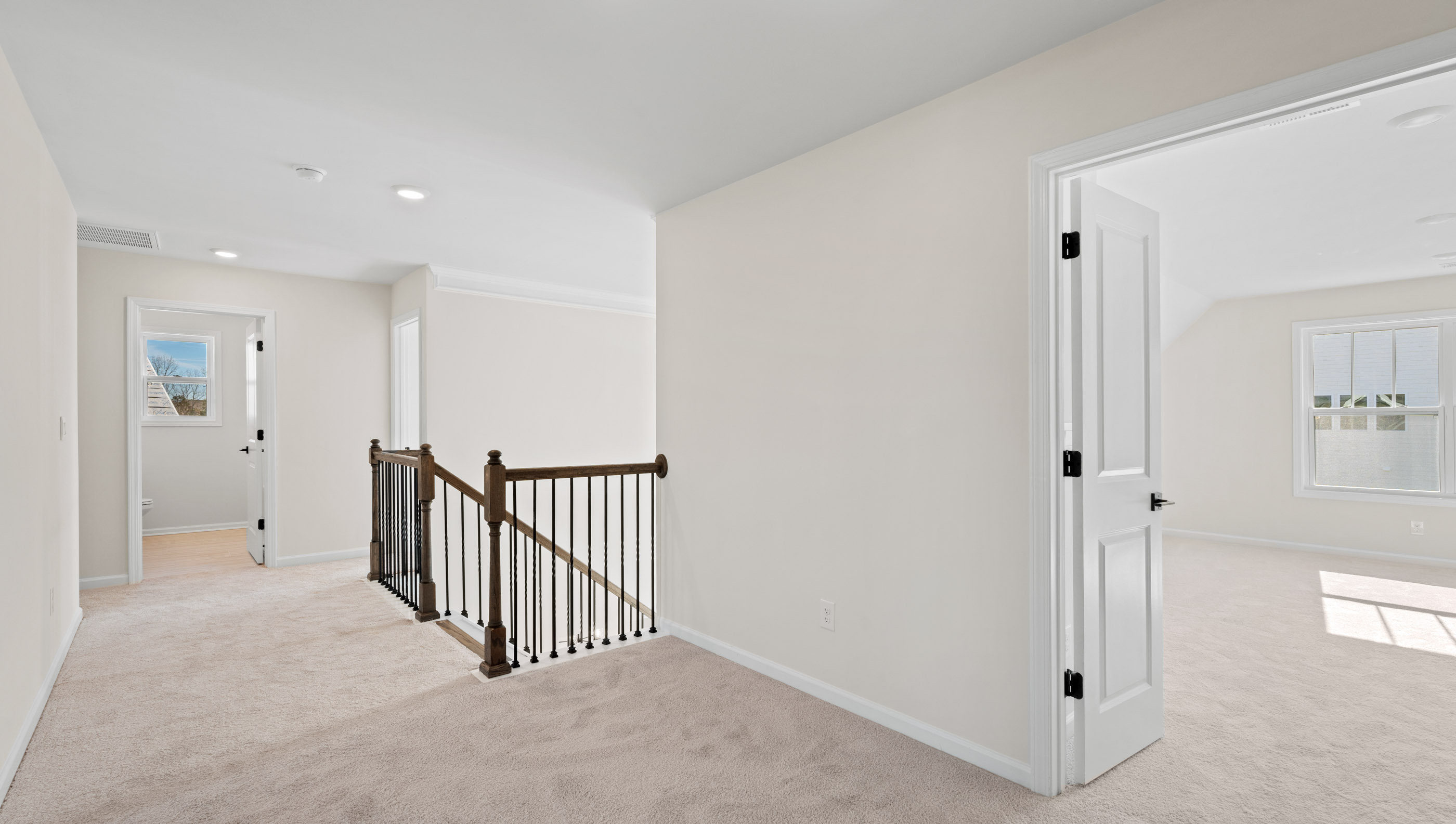 Loft area with carpet and windows.