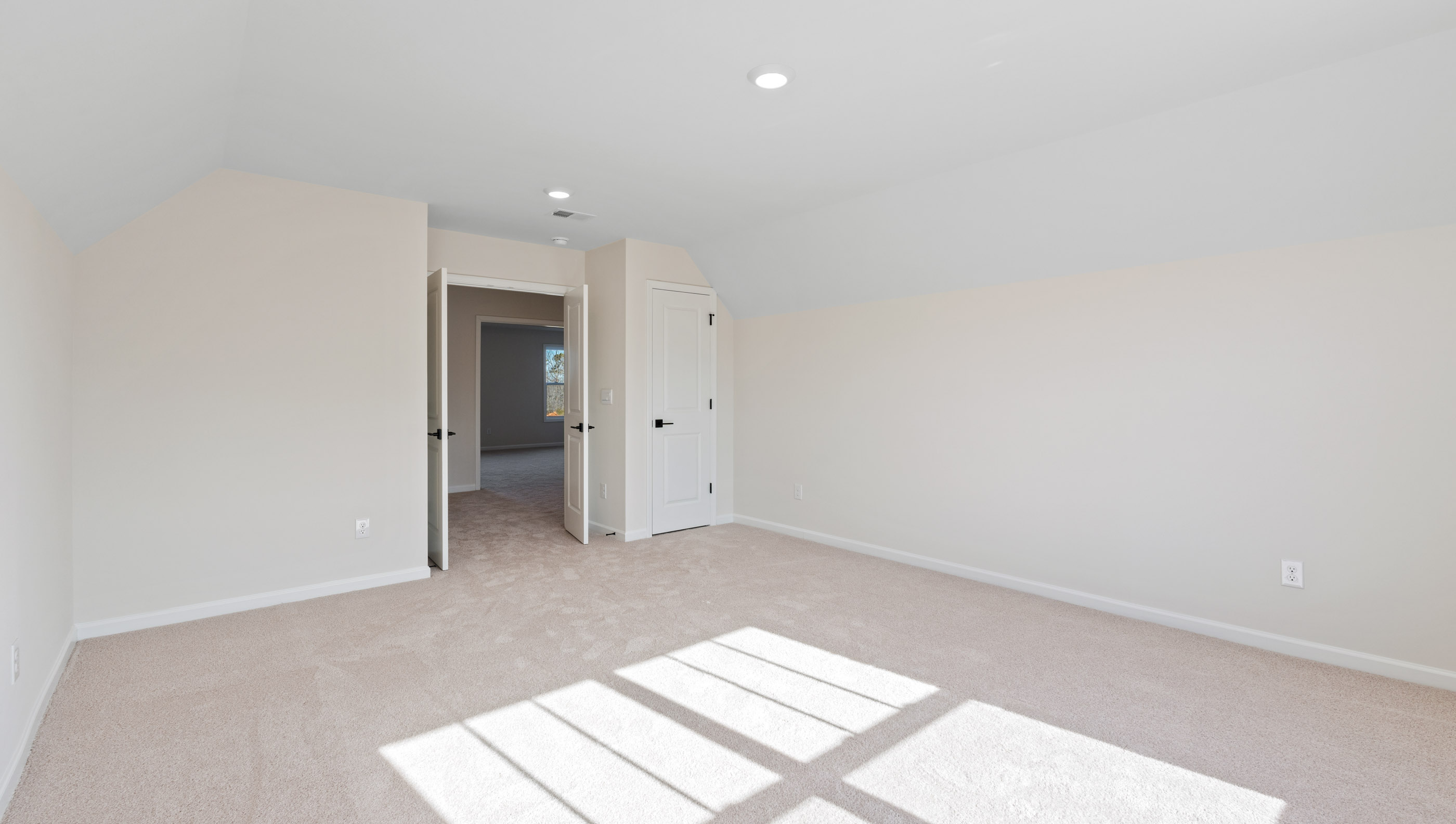 Bedroom with carpet and windows.