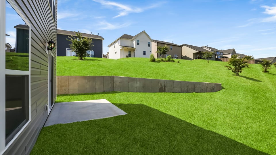 Back exterior of home with patio.