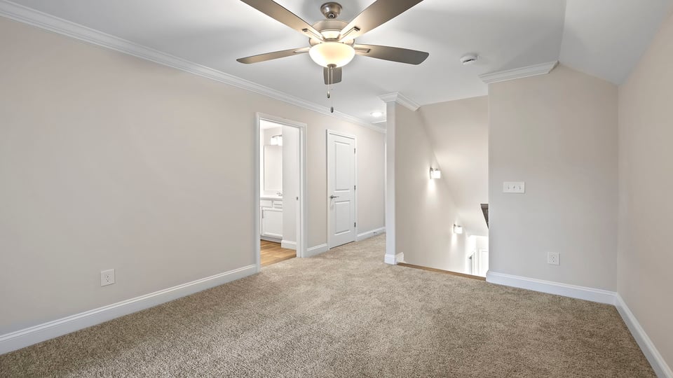 Bedroom with window, ceiling fan and carpet.