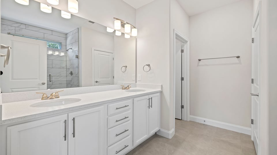 Primary bathroom with dual sink vanity.