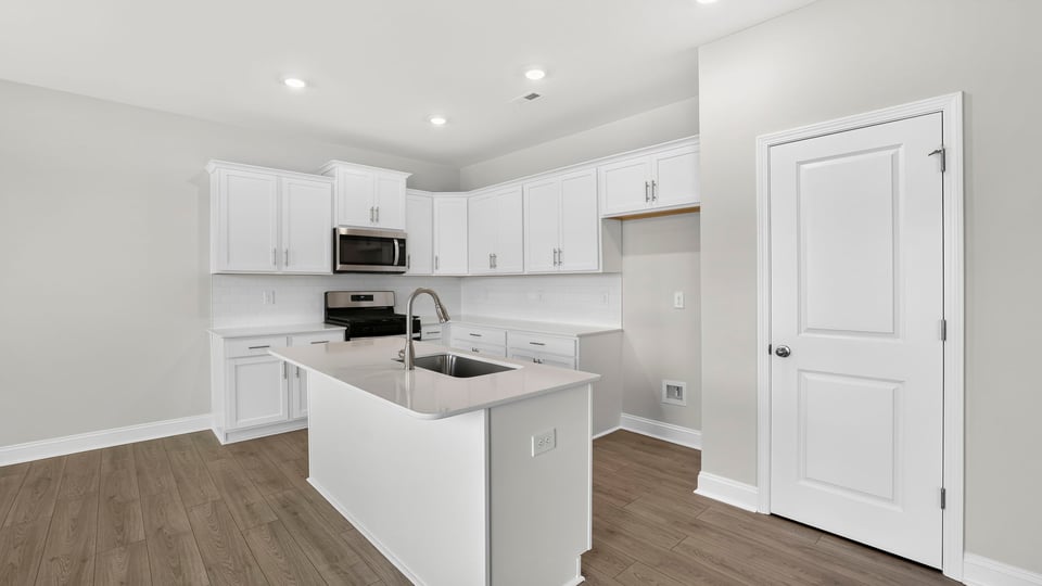 Kitchen and island with quartz countertops.