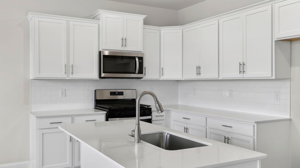 Kitchen and island with quartz countertops.