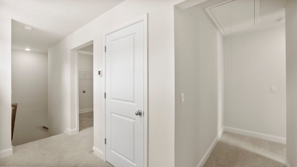 Hallway with carpet.