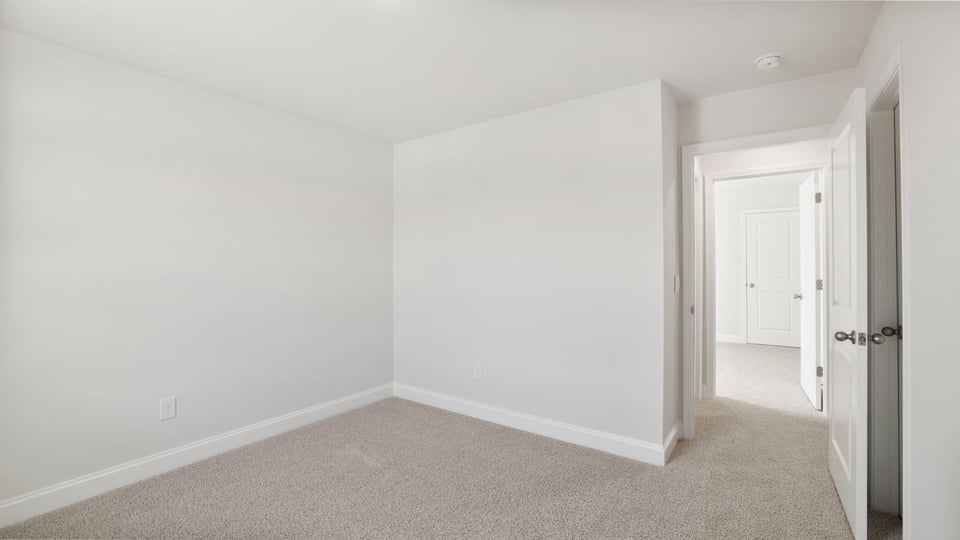 Bedroom with carpet and window.