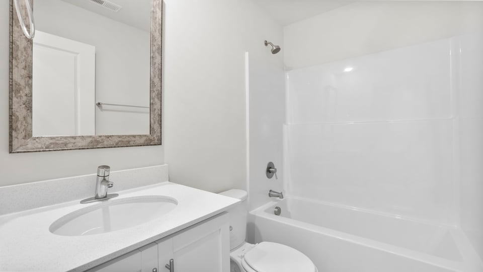 Bathroom with single vanity sink and bathtub.