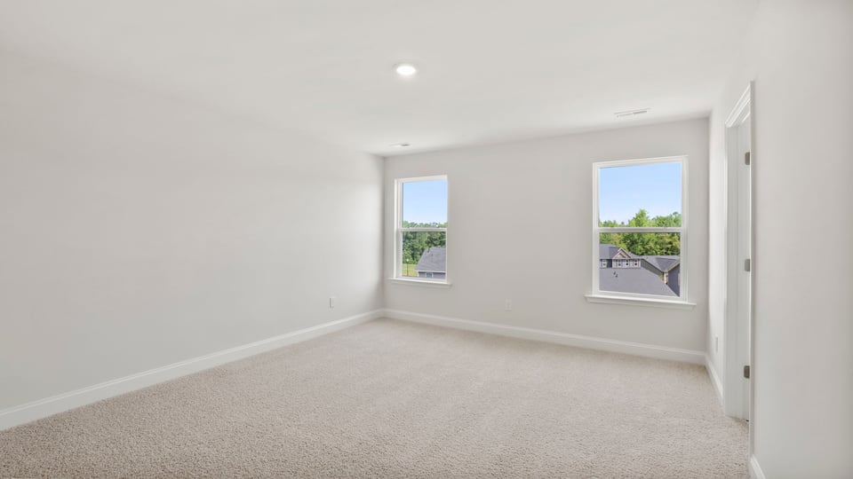 Bedroom with carpet and window.
