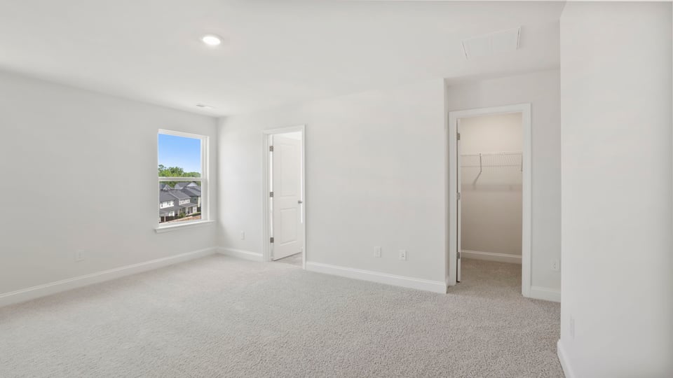 Bedroom with carpet and window.