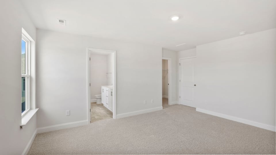 Bedroom with carpet and window.