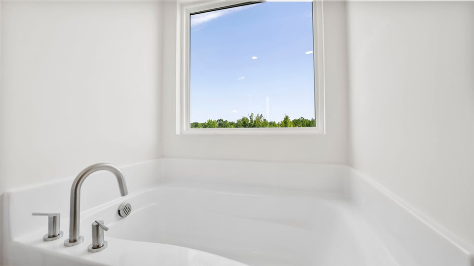 Bathtub in bathroom.