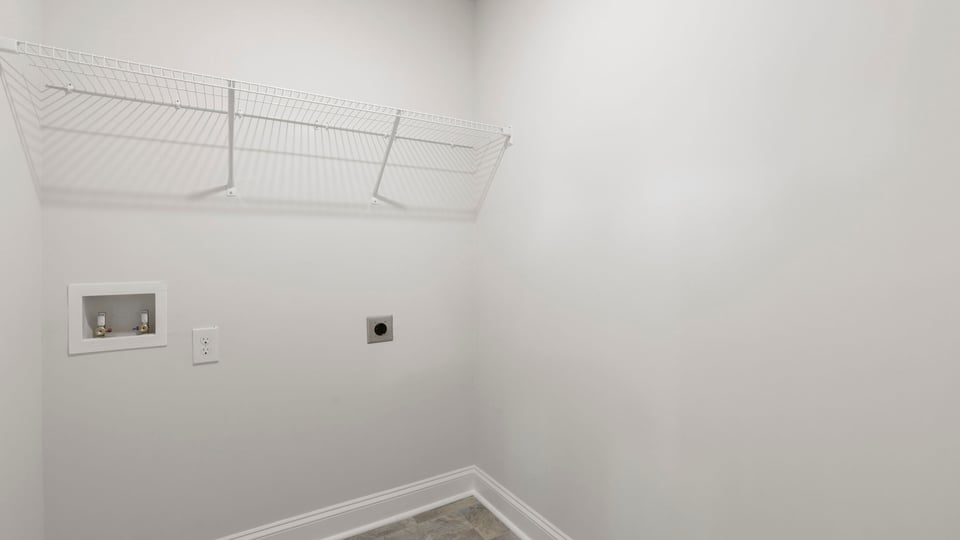 Laundry room with hanging storage racks.