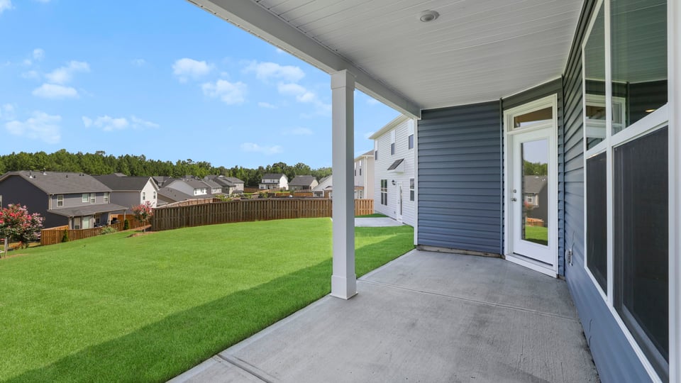 Back exterior of home with covered patio.