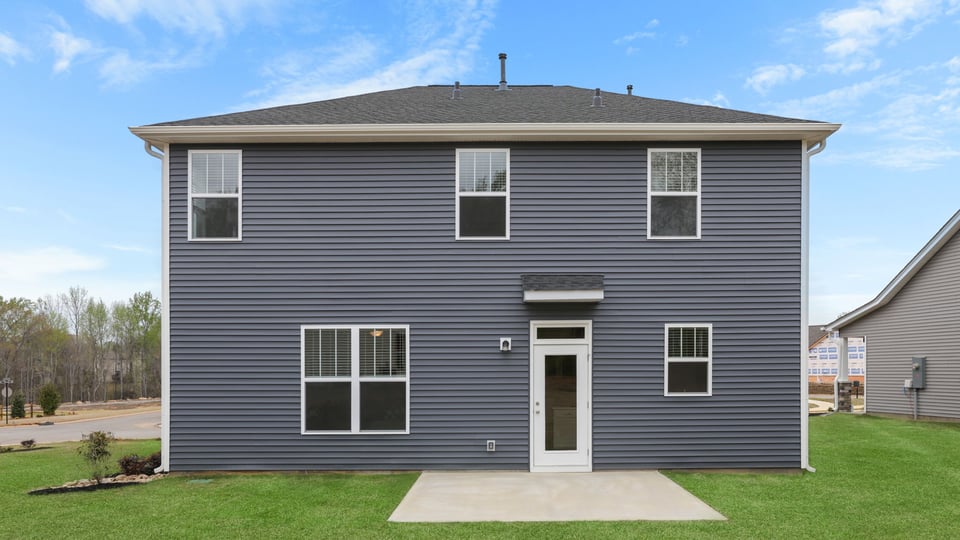 Back exterior with large backyard.