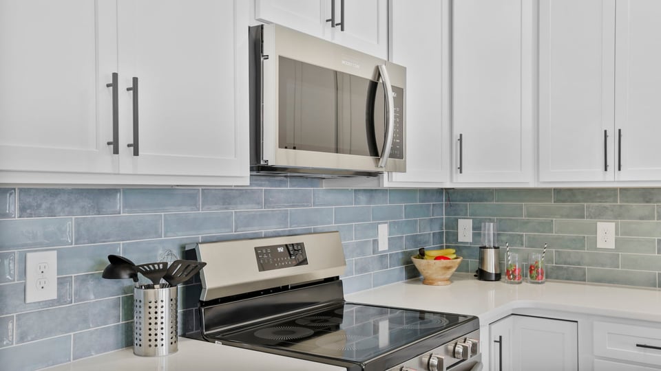 Kitchen with island and cabinets.