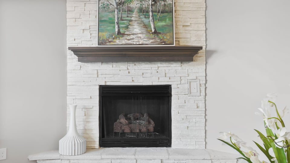 Living room with fireplace and windows.