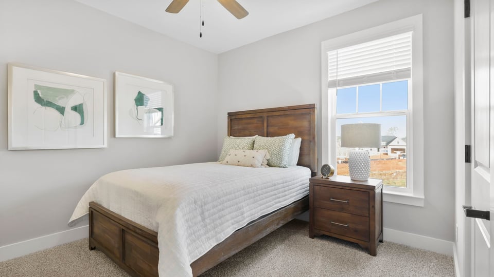 Bedroom with carpet and window.