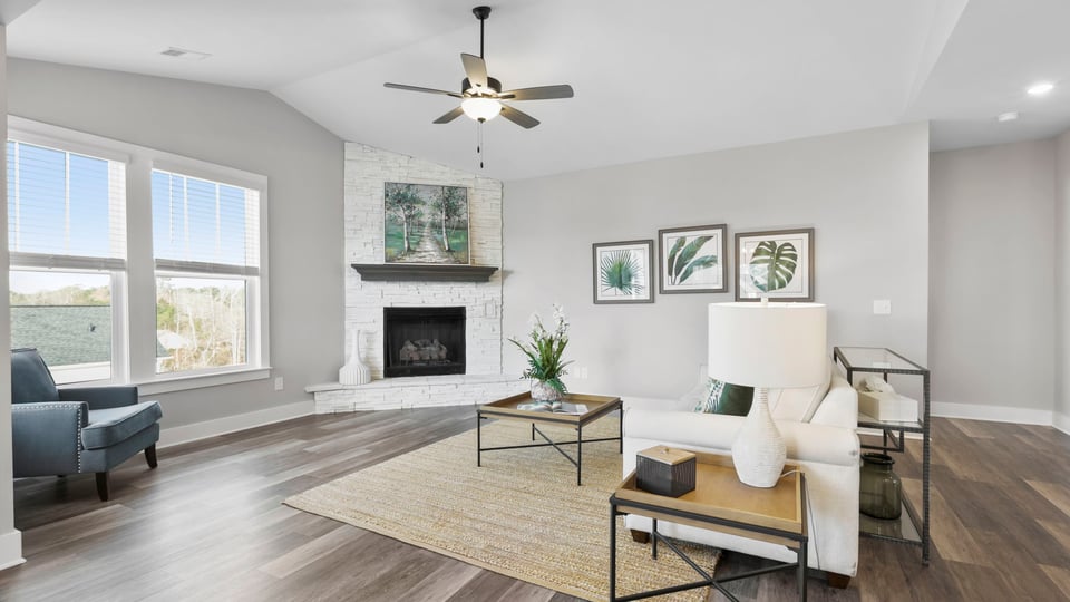 Living room with fireplace and windows.