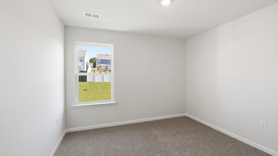 Bedroom with carpet and window.