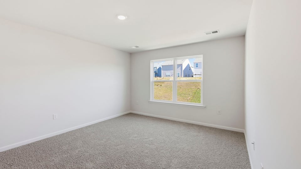 Bedroom with carpet and window.