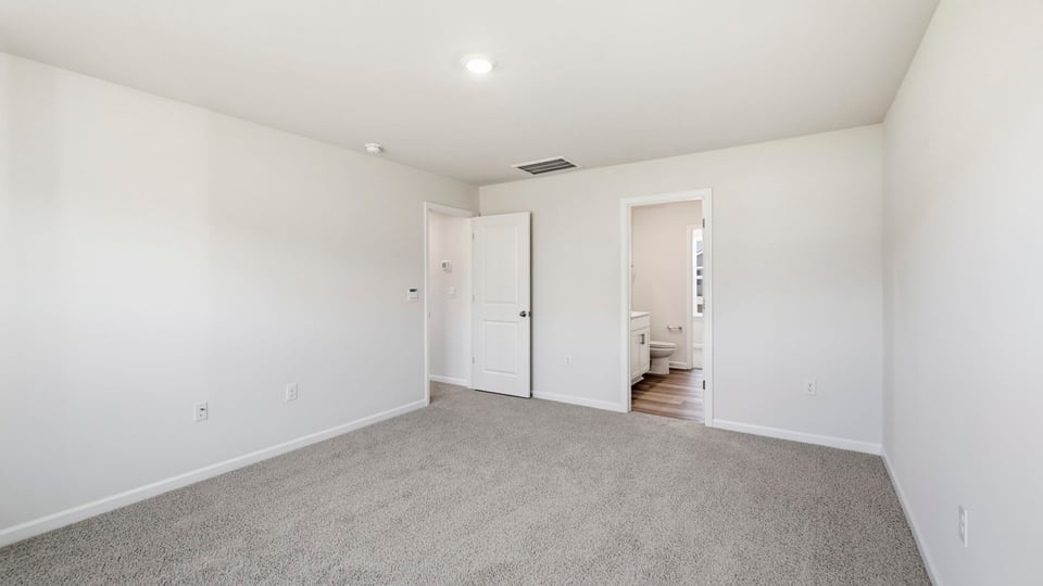 Bedroom with carpet and window.