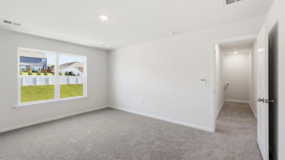 Bedroom with carpet and window.