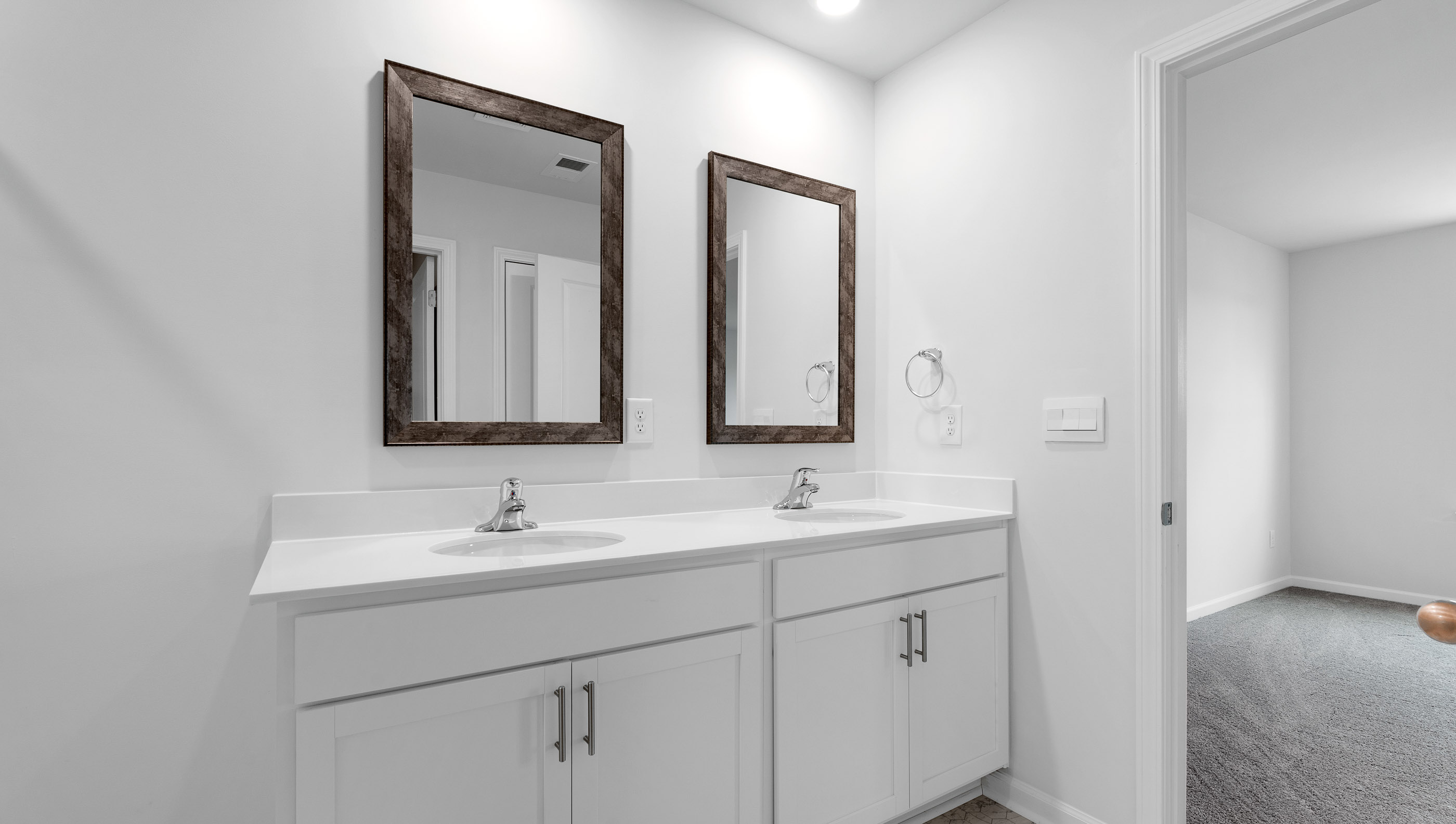 Bathroom with double vanity and walk in shower.