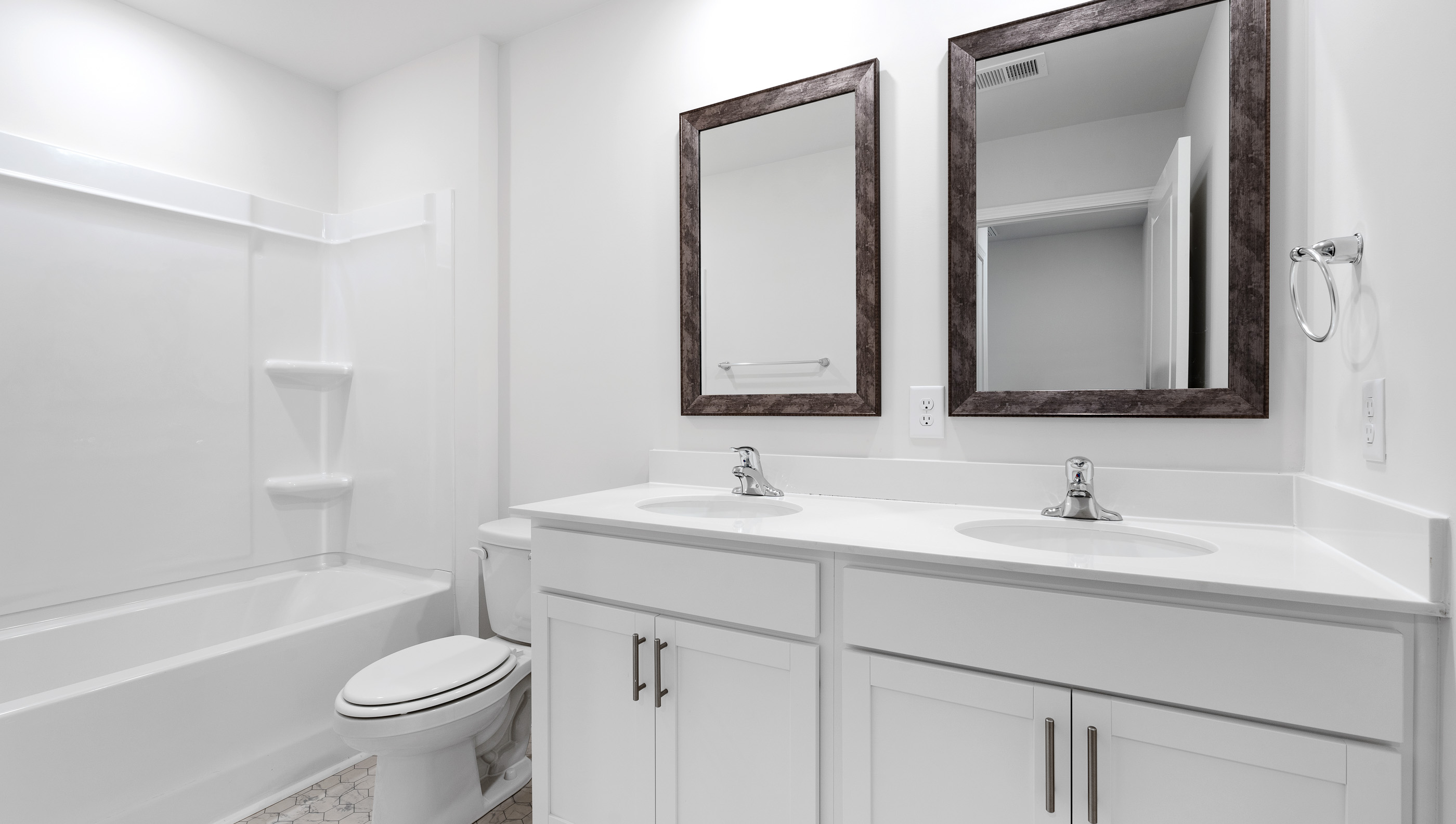 Bathroom with double vanity and walk in shower.