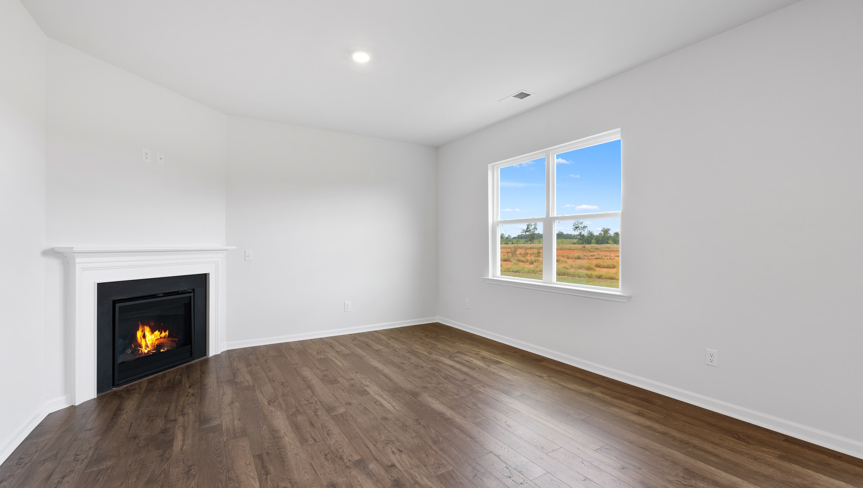 Livingroom with windows and fireplace.
