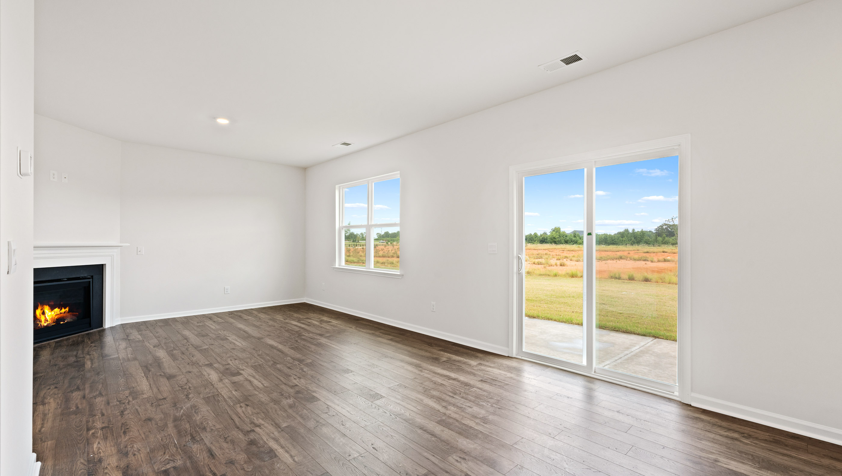Livingroom with windows and fireplace.