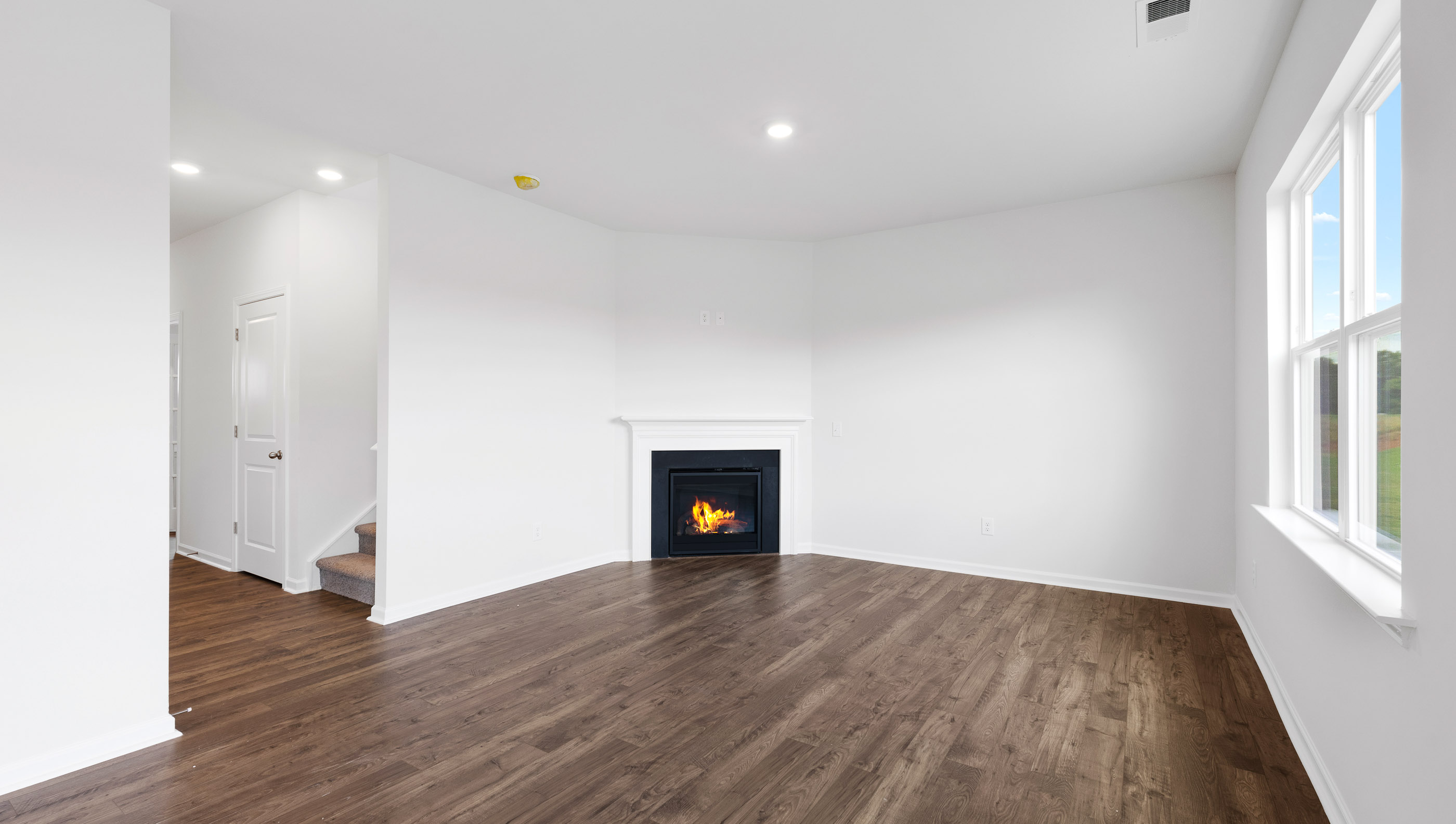 Livingroom with windows and fireplace.