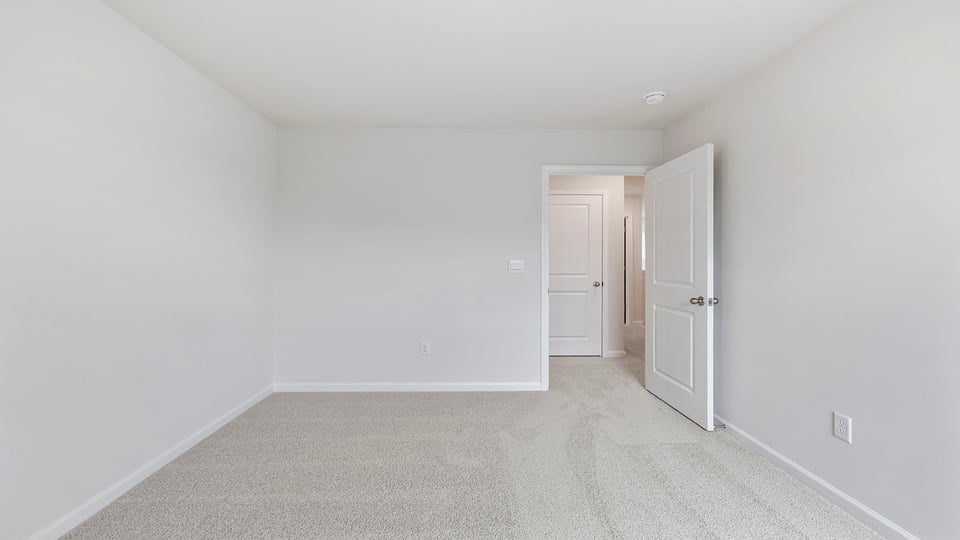 Bedroom with carpet and window.